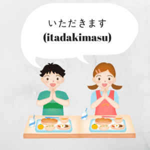 deux enfants qui s’apprêtent à manger et disent itadakimasu en japonais.